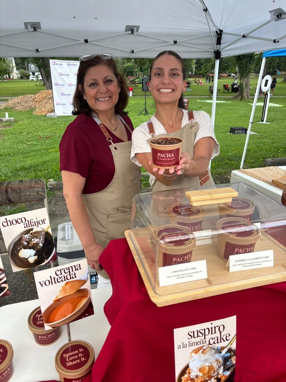 Rosanna and Ximena offering a PACHA dessert at an event
